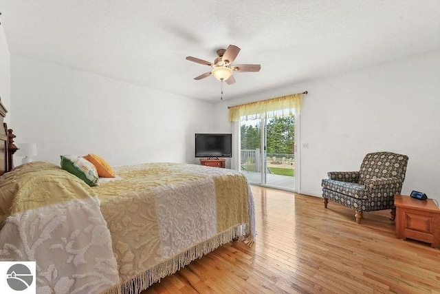 bedroom with wood-type flooring, access to outside, and ceiling fan