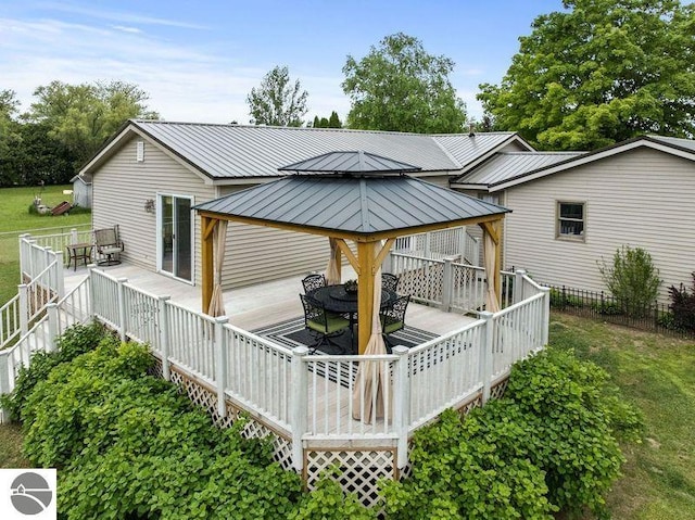 back of property with a gazebo and a deck