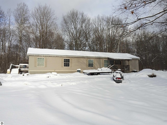 view of snow covered rear of property