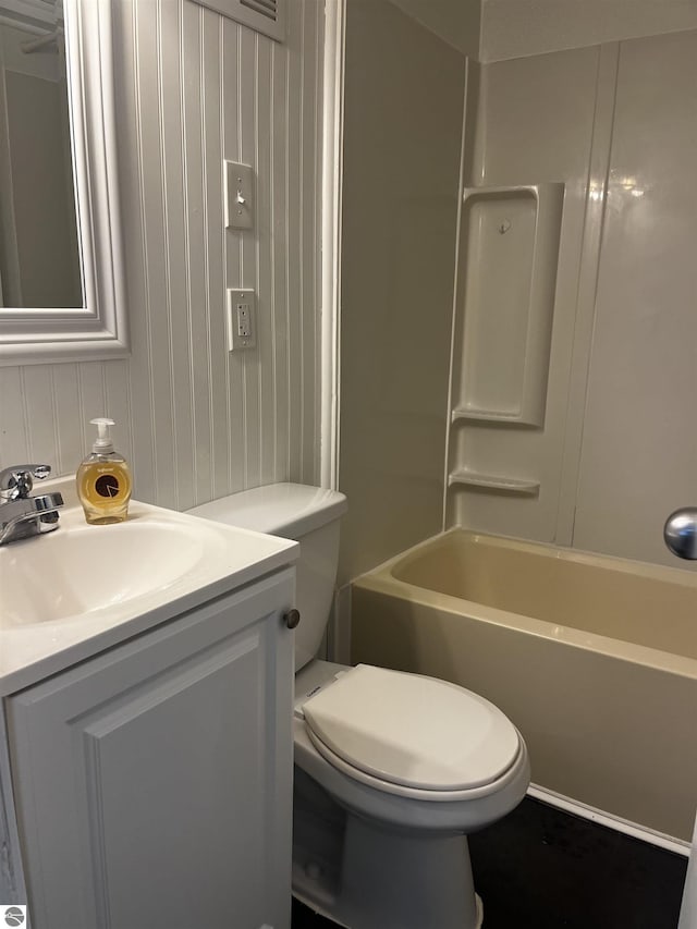 full bathroom featuring vanity, toilet, and washtub / shower combination