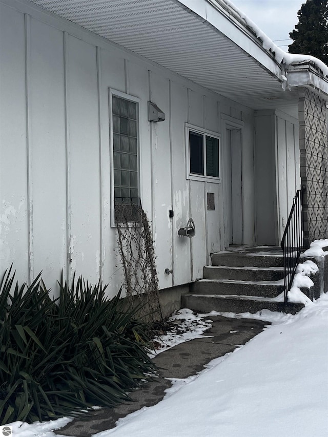 view of snow covered property entrance