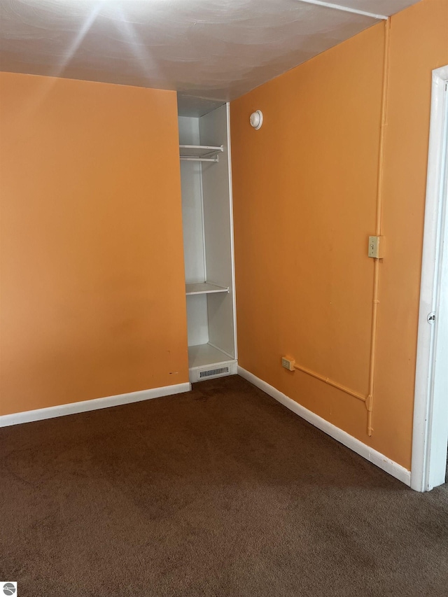 unfurnished bedroom with carpet and a closet