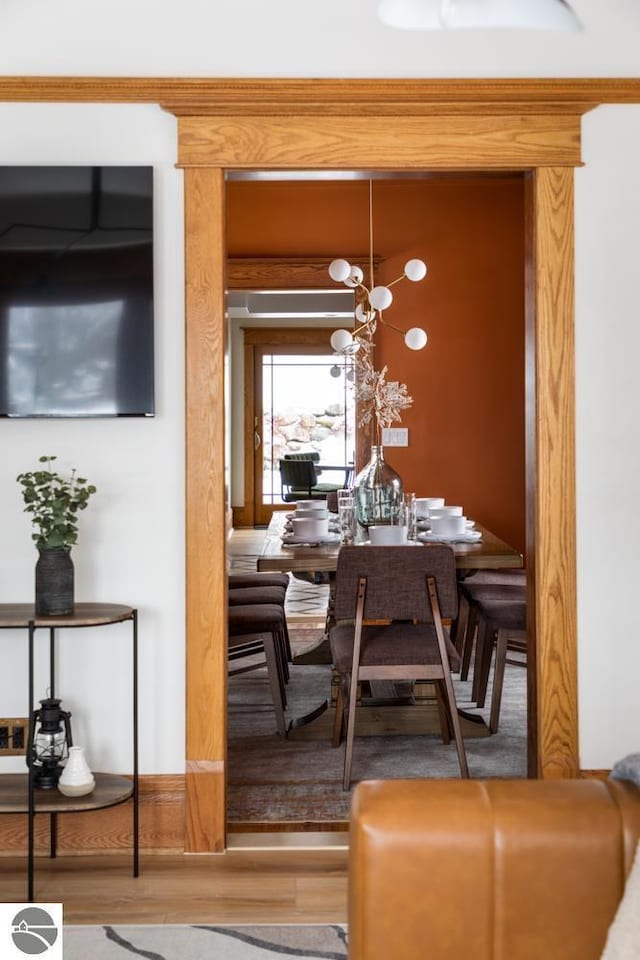 dining area featuring an inviting chandelier and hardwood / wood-style floors