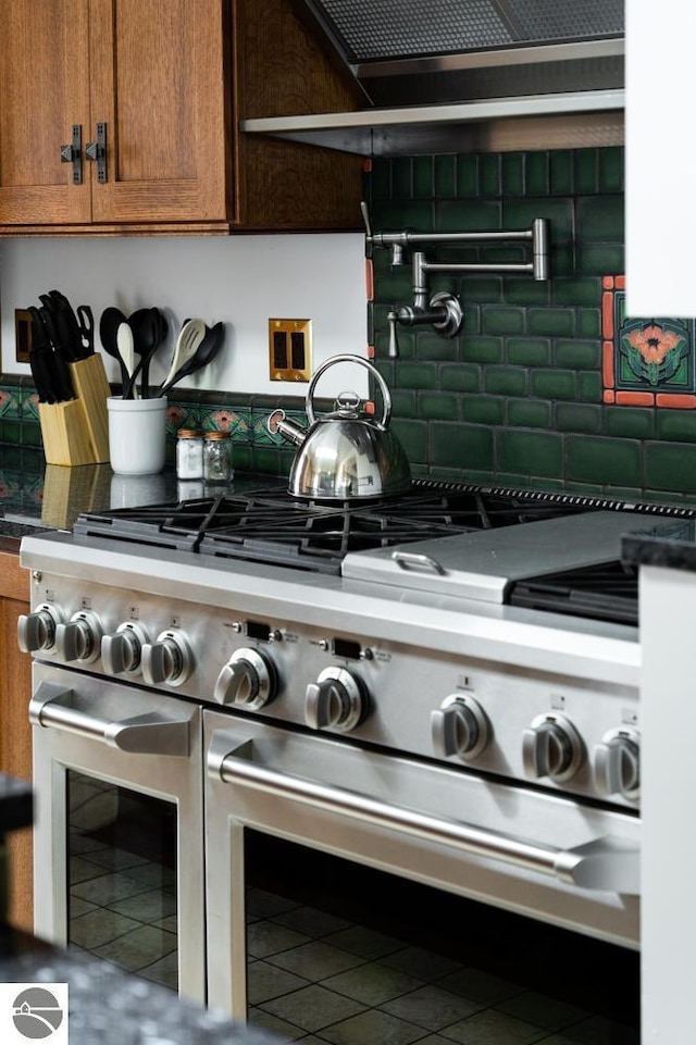 interior space featuring double oven range and ventilation hood