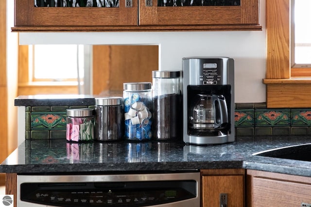 interior details featuring dark stone counters and dishwashing machine