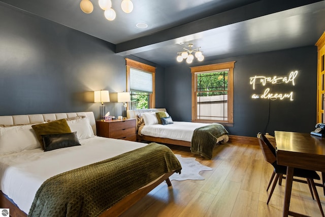 bedroom featuring hardwood / wood-style flooring and beam ceiling