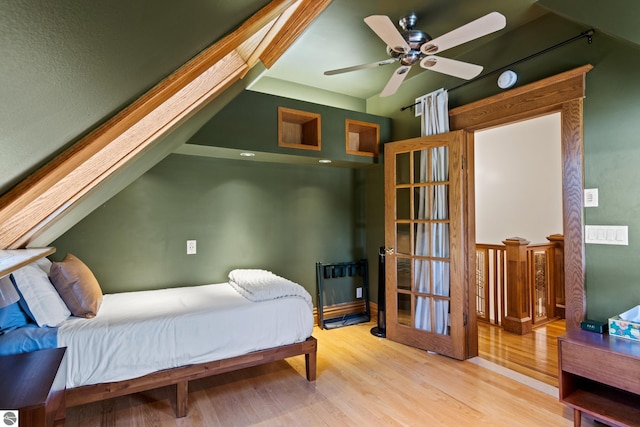 bedroom featuring ceiling fan, vaulted ceiling, and light wood-type flooring