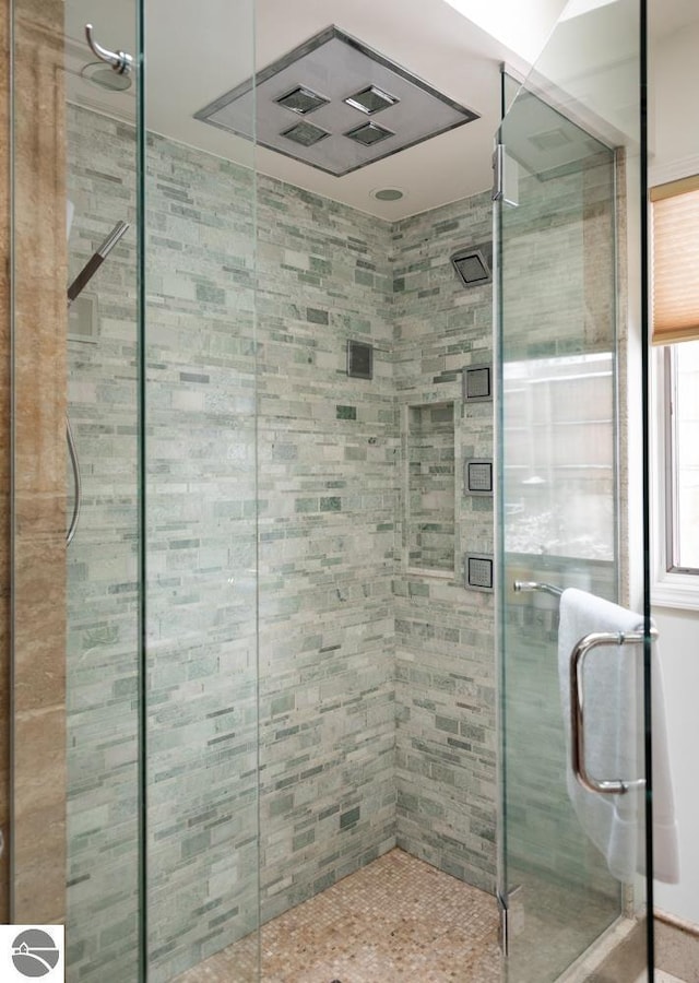 bathroom with a shower with door