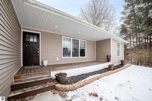 view of snow covered property entrance