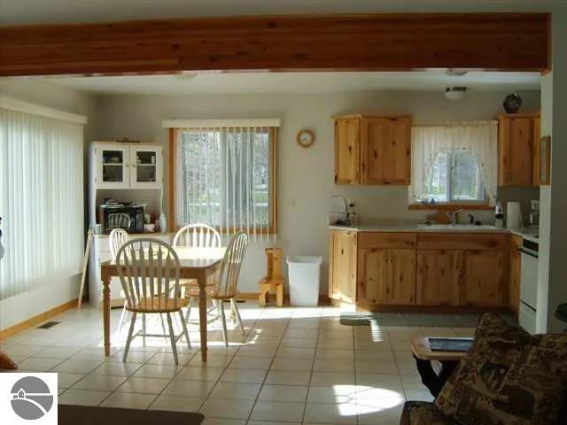 kitchen featuring stove, sink, and light tile patterned floors