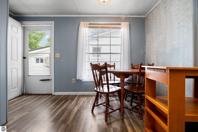 dining space featuring ornamental molding and dark hardwood / wood-style floors