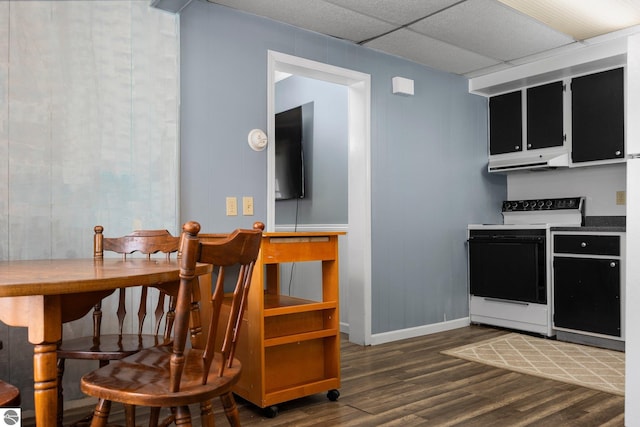 kitchen featuring a drop ceiling, dark wood-type flooring, and white range with electric stovetop