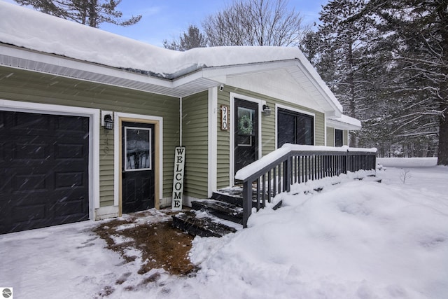 view of snow covered property entrance