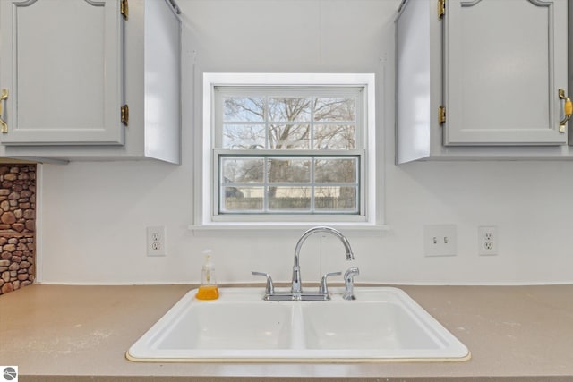 kitchen featuring white cabinetry and sink