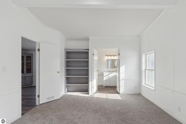 unfurnished bedroom featuring light carpet