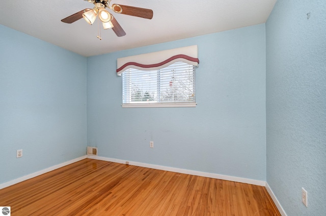 spare room featuring hardwood / wood-style flooring and ceiling fan