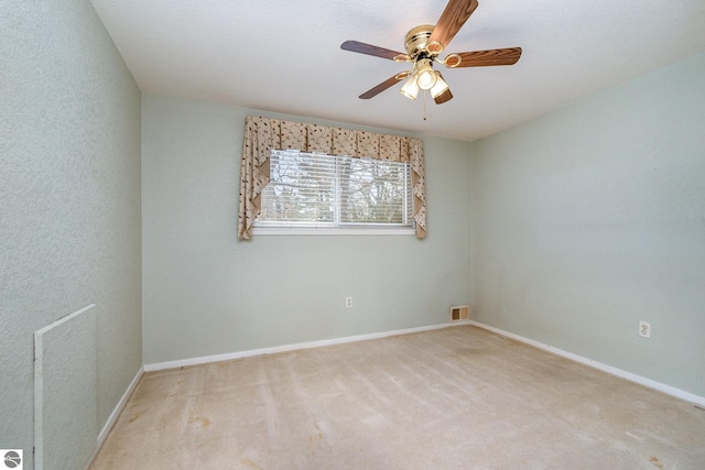 spare room featuring ceiling fan and carpet flooring