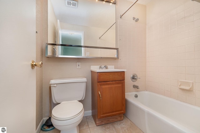 full bathroom featuring tiled shower / bath, vanity, toilet, and tile patterned flooring