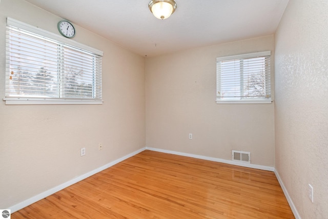 spare room with wood-type flooring