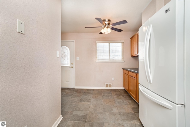 kitchen with white refrigerator and ceiling fan