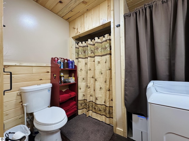 bathroom featuring washer / clothes dryer, toilet, wooden ceiling, and wood walls