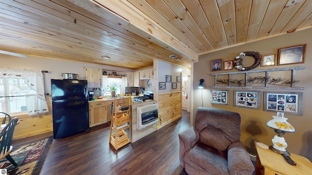 kitchen with dark wood-type flooring, heating unit, wood walls, black fridge, and wood ceiling