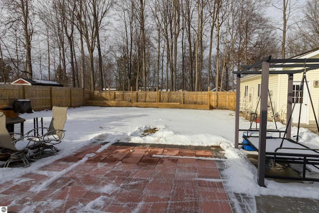 snow covered patio featuring a pergola