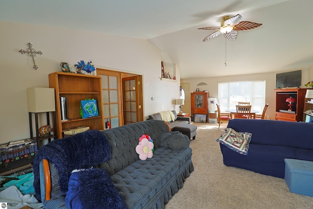 living room featuring lofted ceiling, ceiling fan, and carpet flooring