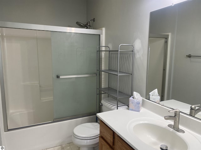 full bathroom with enclosed tub / shower combo, vanity, and toilet