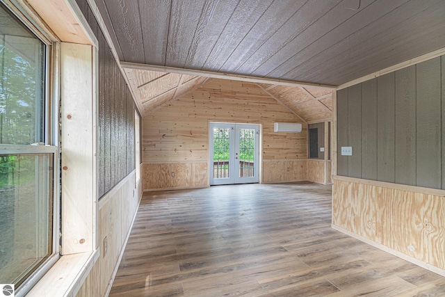 additional living space with french doors, lofted ceiling, wood walls, wood-type flooring, and wooden ceiling