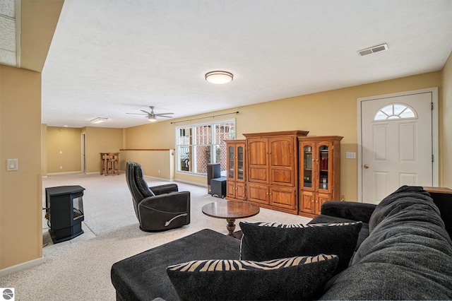 living room with visible vents, ceiling fan, baseboards, and carpet floors