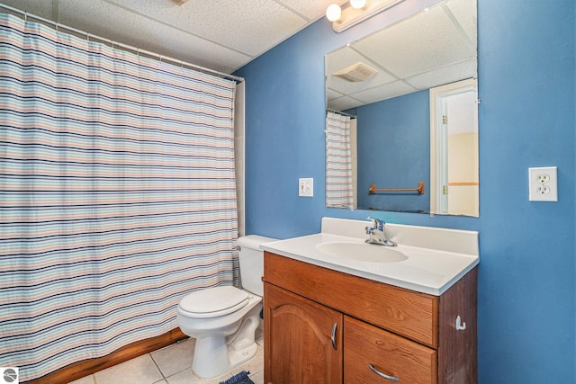 bathroom featuring visible vents, toilet, a drop ceiling, tile patterned flooring, and vanity