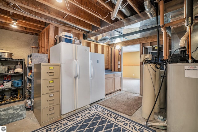 unfinished below grade area featuring water heater and freestanding refrigerator