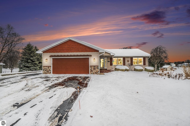 view of front of home featuring stone siding and an attached garage