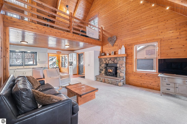 carpeted living room with wooden ceiling, high vaulted ceiling, and wood walls