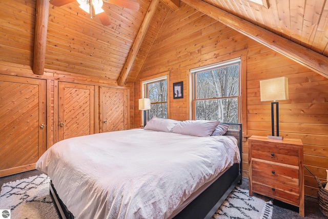 carpeted bedroom with ceiling fan, wooden walls, wooden ceiling, and beam ceiling