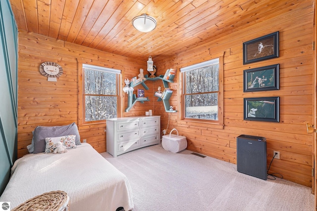 carpeted bedroom featuring wood ceiling and wood walls