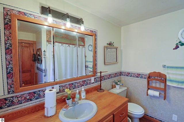 bathroom featuring baseboard heating, vanity, and toilet