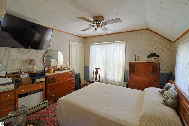 bedroom featuring ceiling fan, ornamental molding, a baseboard radiator, and lofted ceiling