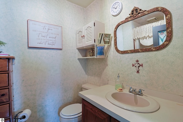 bathroom featuring vanity and toilet