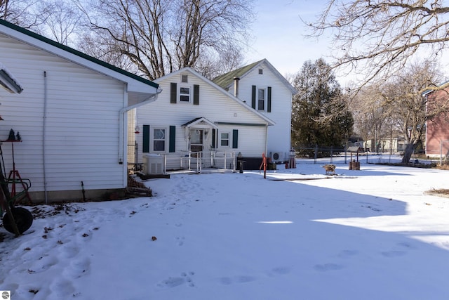 snow covered property featuring central AC unit