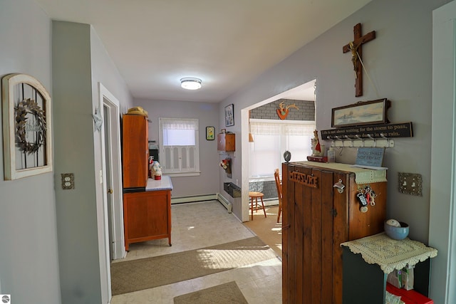 corridor featuring a baseboard heating unit