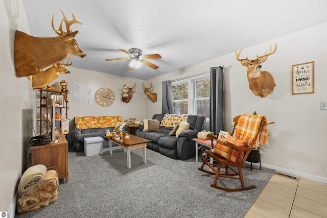 tiled living room with ceiling fan