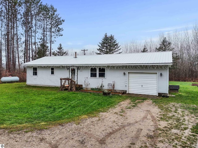 single story home with a garage and a front lawn