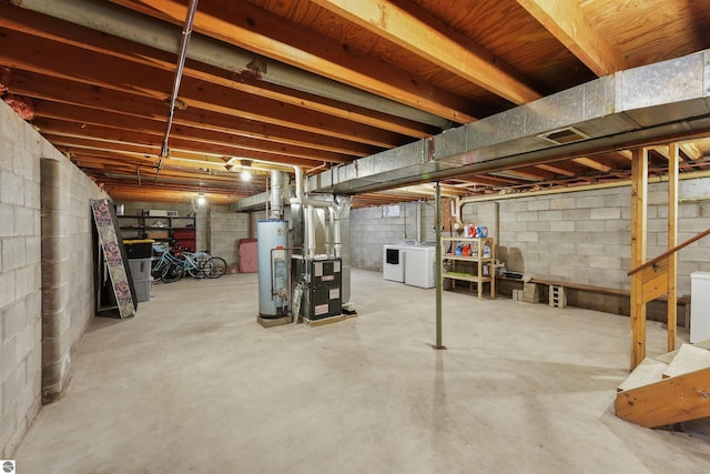 basement featuring separate washer and dryer, heating unit, and water heater