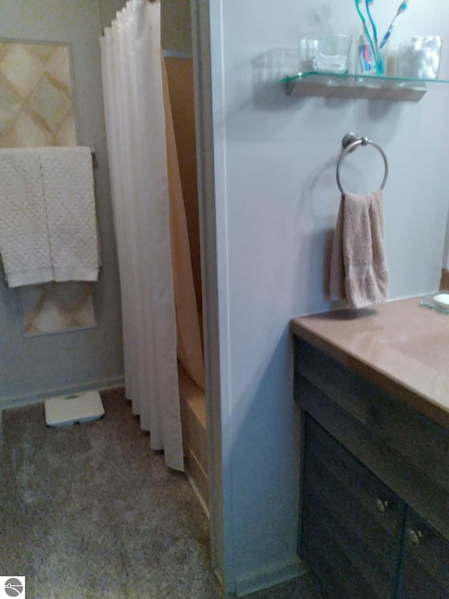 bathroom featuring shower / tub combo and vanity
