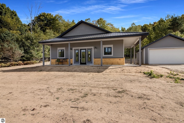 view of front facade with a garage, an outdoor structure, and covered porch