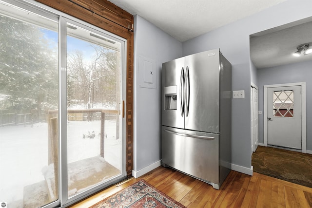 kitchen featuring hardwood / wood-style floors and stainless steel fridge