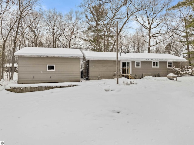 view of snow covered back of property