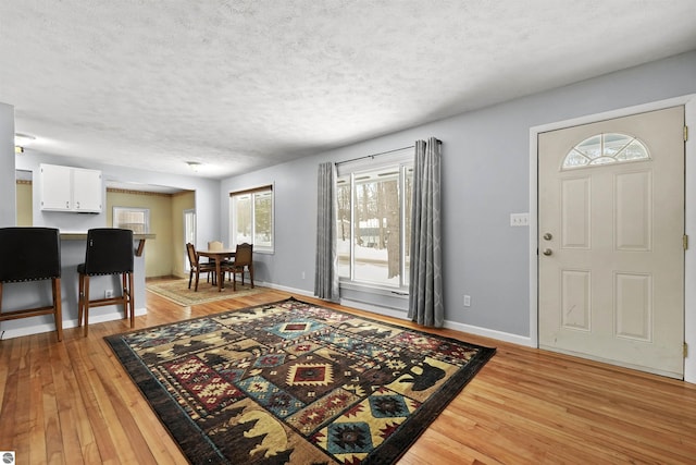 foyer featuring a textured ceiling and light hardwood / wood-style flooring